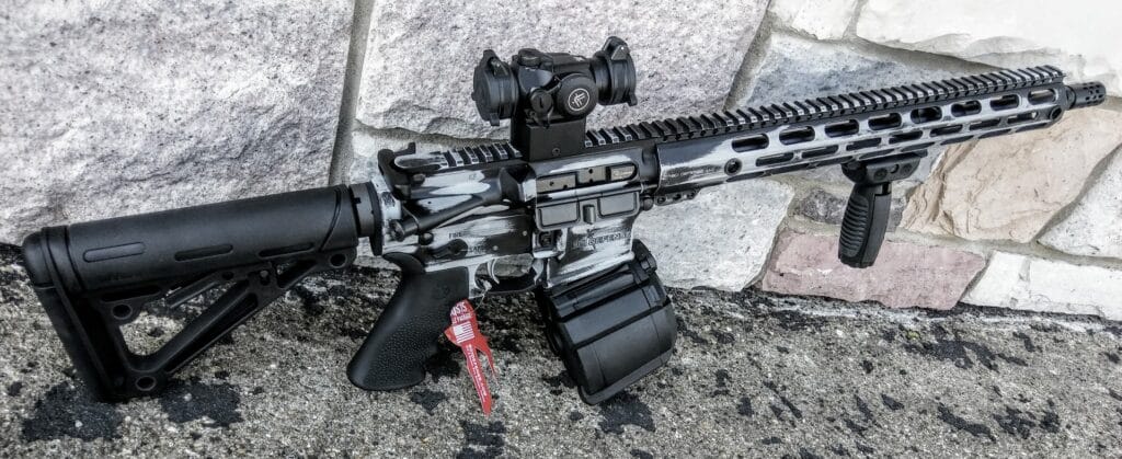 decked out rifle with pistol grip, buttstock, scope and verticle foregrip